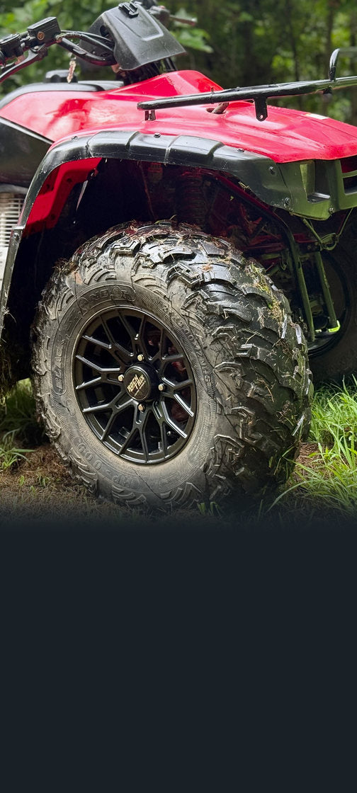 Rocktrix wheels on a red ATV on a grassy trail
