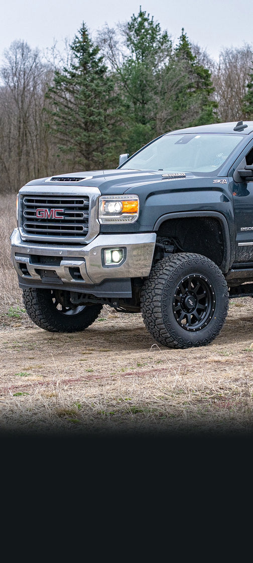 Rocktrix RT111 8 lug black wheels on a GMC Sierra 2500 in a field