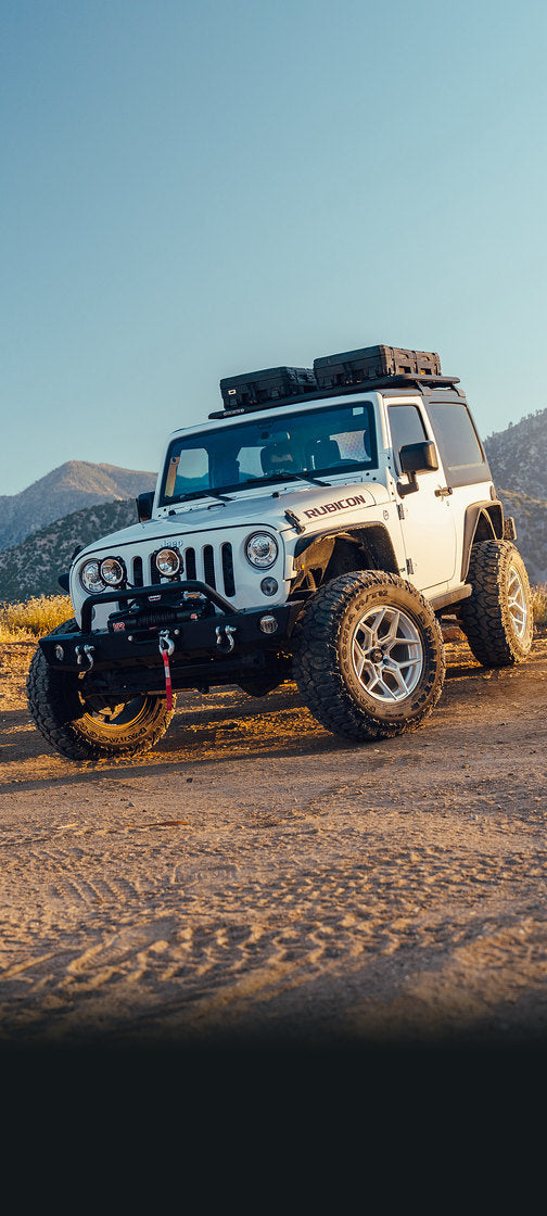 Rocktrix RT105 Machined Silver wheels on a white Jeep JK on a dirt trail